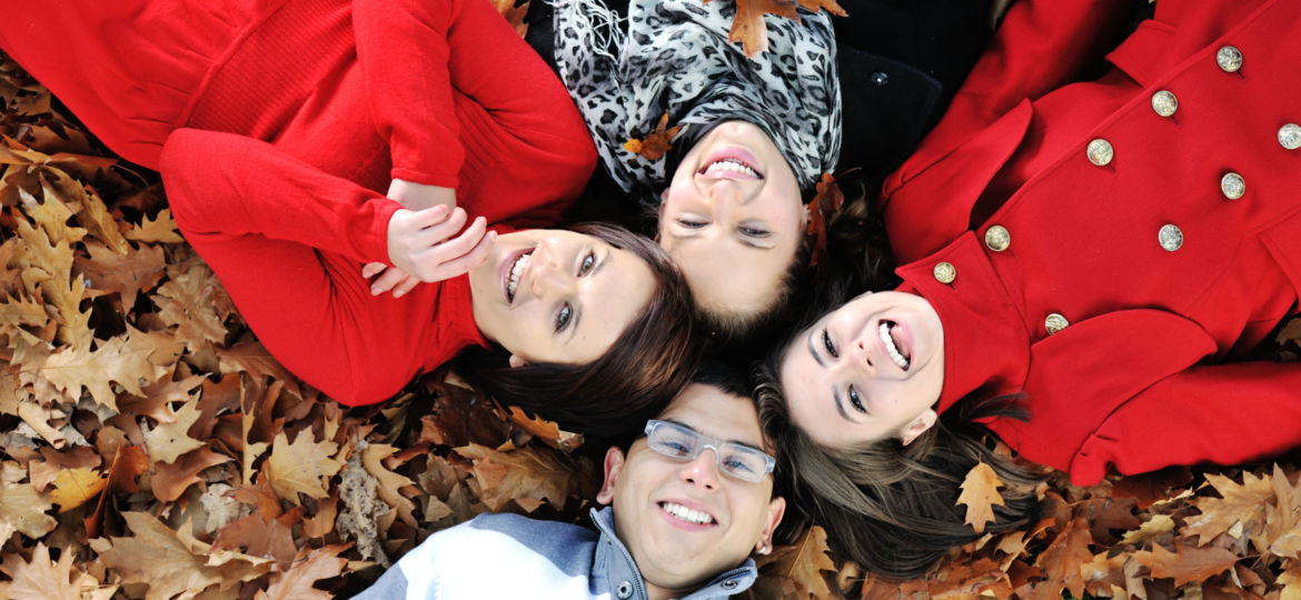 Happy group of young friends together in fall park