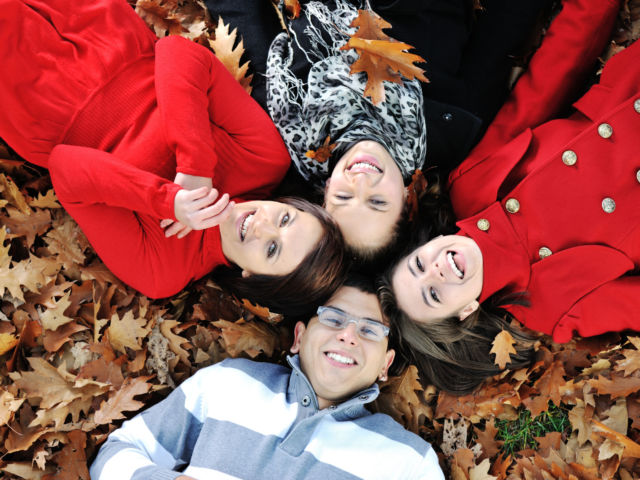 Happy group of young friends together in fall park